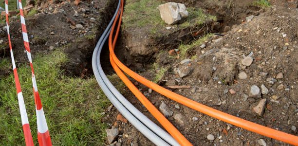 underground cable connecting infrastructure installation. Construction site with communication Cables protected in tubes. high speed Internet Network cables are buried on the street